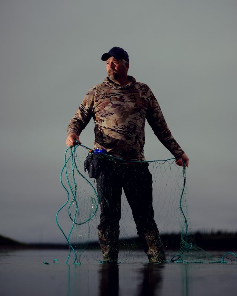 William Larkham Jr. of 'Alone' Season 11 holding fishing line