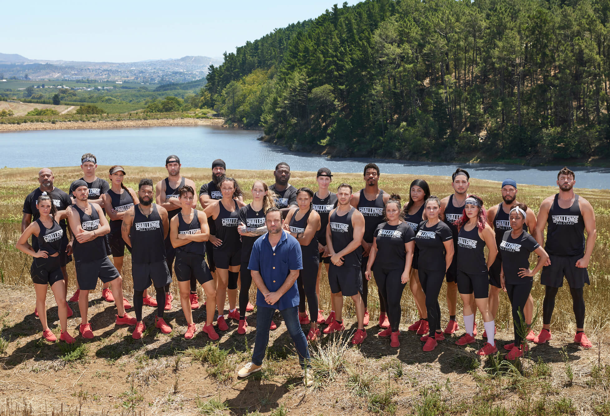 'The Challenge: All Stars' Season 4 cast posing behind T.J. Lavin outside