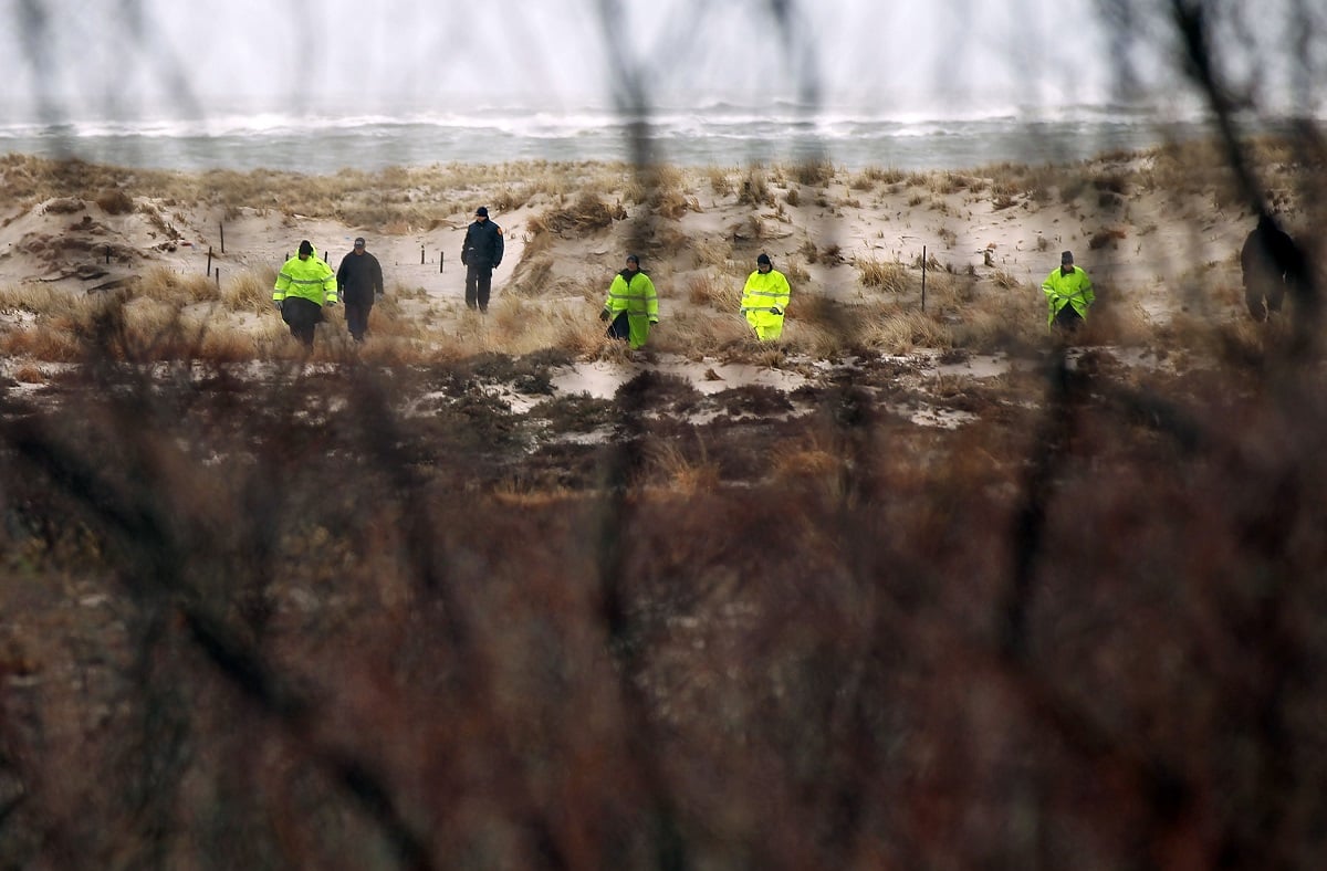 Police work on the beach in Babylon, New York after the discovery of human remains. The remains are associated with the Long Island Serial Killer.