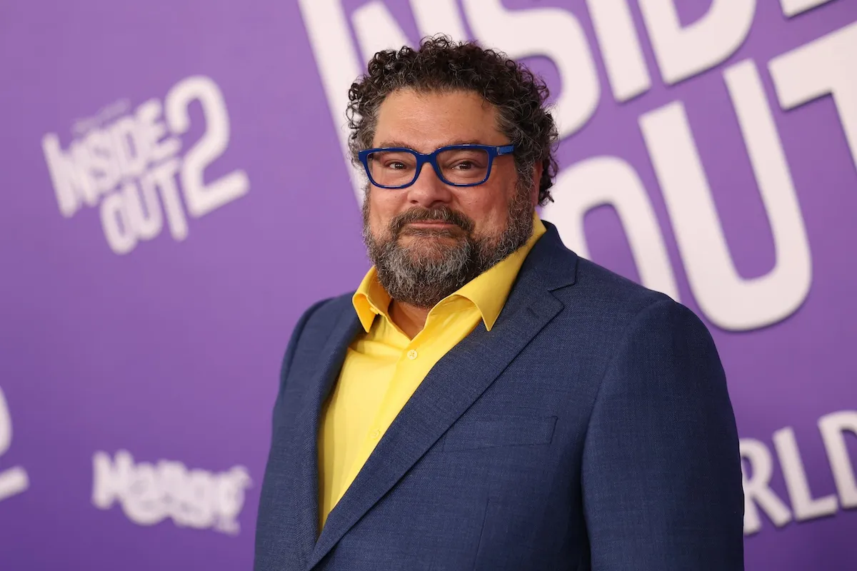 Bobby Moynihan in a suit and a yellow shirt at the Inside Out 2 premiere