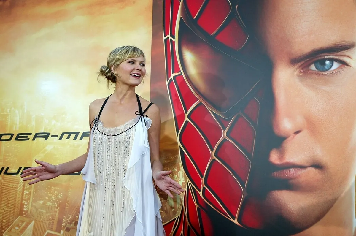 Kirsten Dunst posing at the premier eof 'Spider-Man 2' in a white dress.