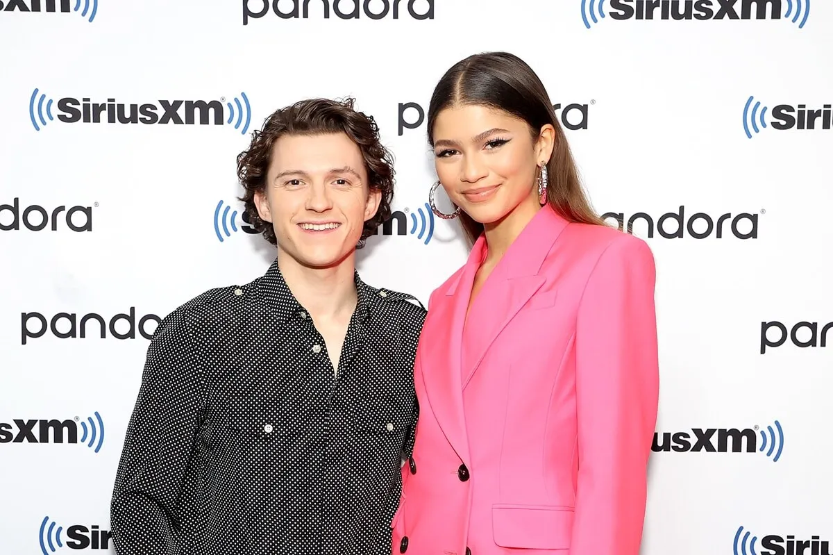 Zendaya and Tom Holland posing at Sirius XM.